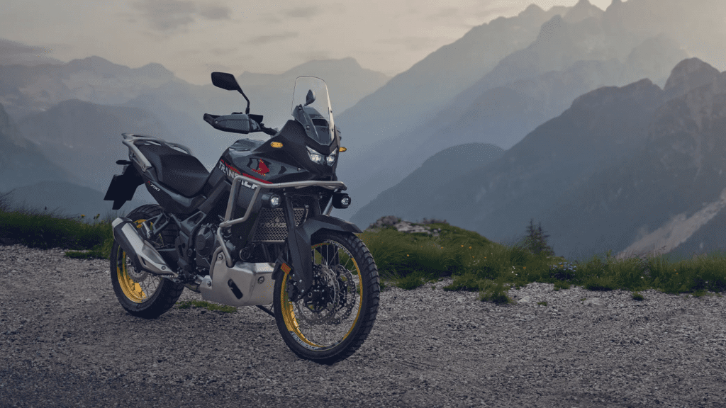 Moto Honda Transalp 700 sur une route de montagne, illustrant l'avis sur sa fiabilité et ses problèmes connus.