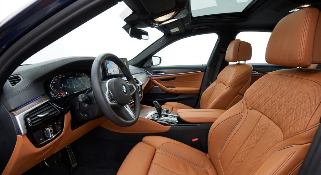 5 raisons de choisir une BMW plutôt qu'une autre marque 3 Vue de l'habitacle moderne d'une BMW avec tableau de bord numérique et finitions premium en cuir